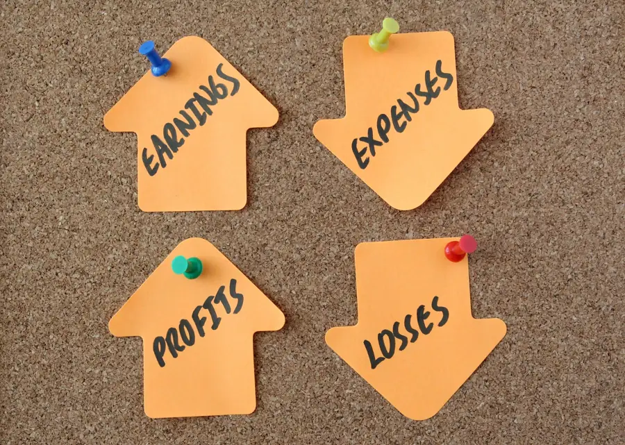 Pinned notes reading earnings, expenses, profits and losses